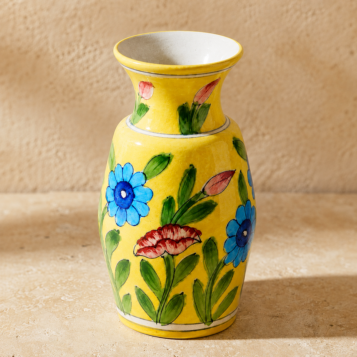 hand painted floral detail on blue pottery vase