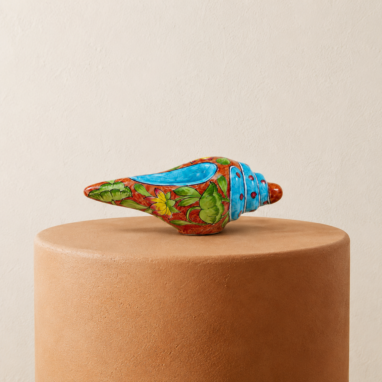Artisan handcrafted terracotta orange and blue shankh shell styled with blue fabric accent for festive home decor