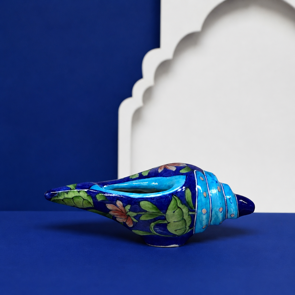 Aditya Blue Art Pottery handpainted terracotta and blue floral conch shell shankh on white background