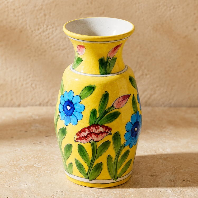hand painted floral detail on blue pottery vase